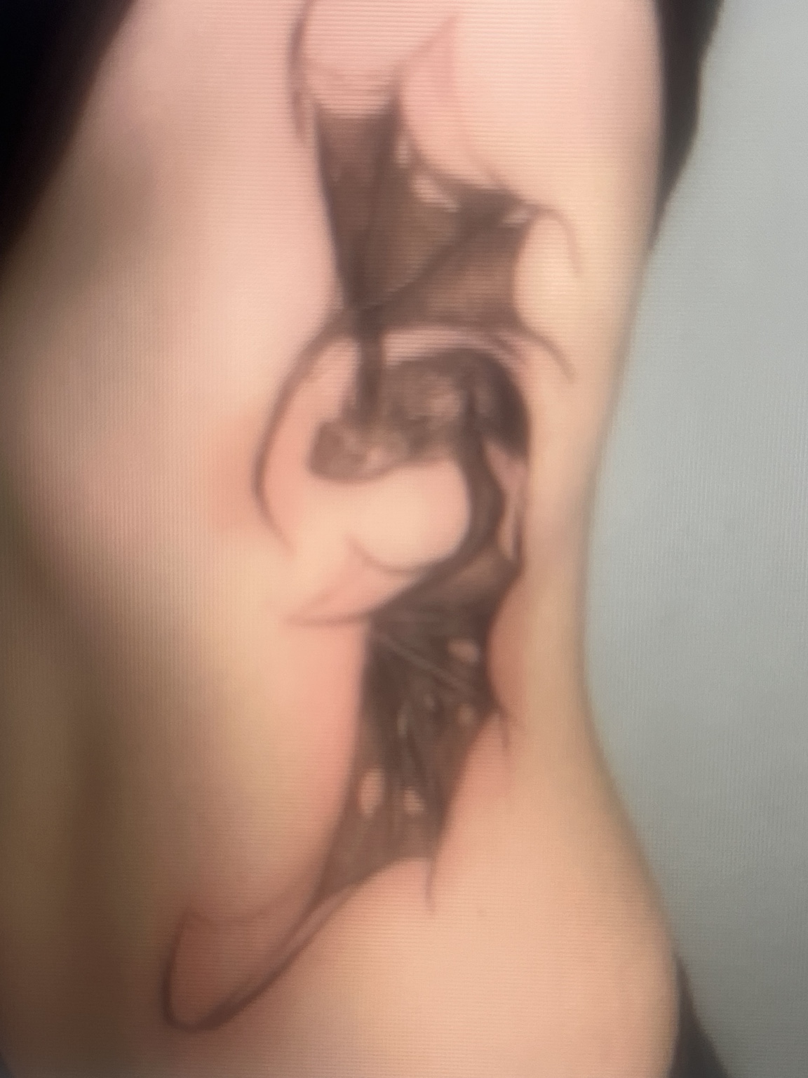 Dark illustrative tattoo on skin